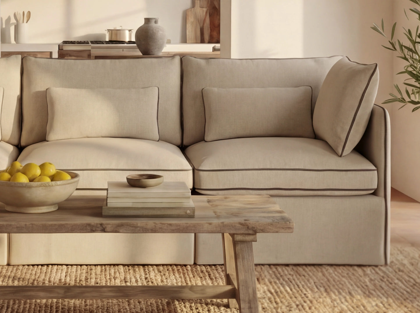 Beige sofa in a living room with a wooden coffee table and decorative items.