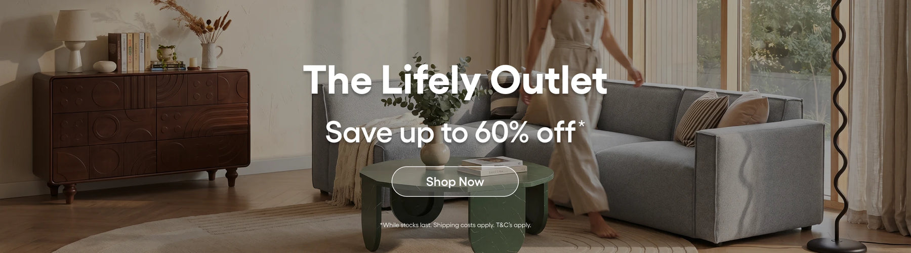 Living room with furniture and a promotional banner for 'The Lifely Outlet' sale.