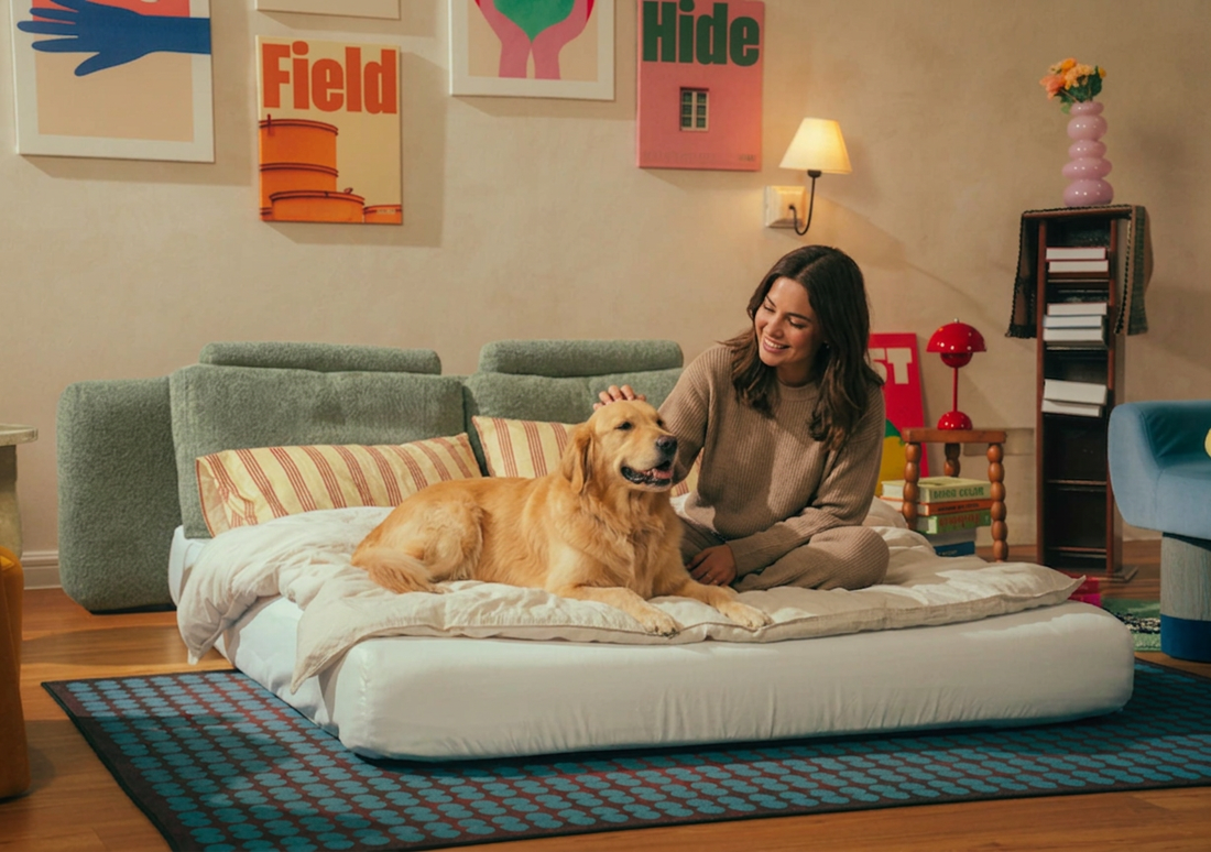 Woman with dog lounging on Snuggle sofa